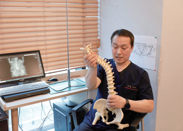 환자의 엑스레이 사진을 보면서 척추 질환이 생긴 원인에 대해 자세히 설명해주고 있다. 사진 박가원 객원기자